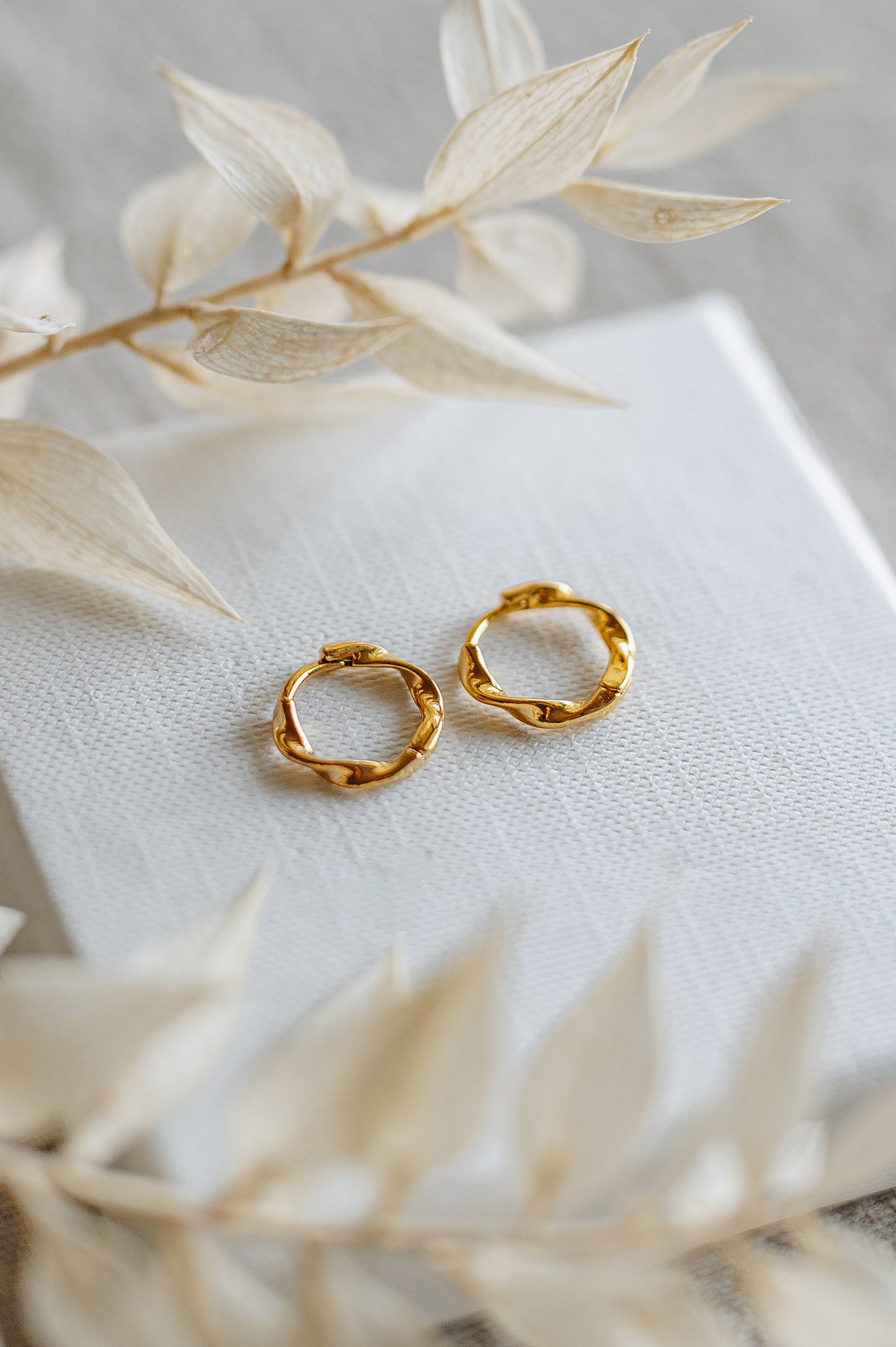 "Crave" twisted hoop earrings